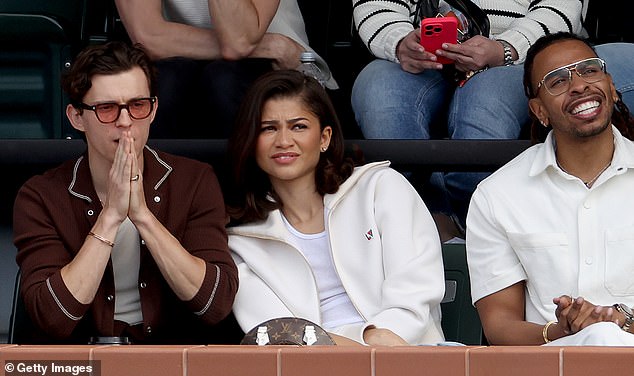 While sitting in the stands, a polo-clad Tom looked handsome as he joined his girlfriend