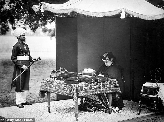 Queen Victoria is cared for by Hafiz Abdul Karim, also known as the Munchi, in 1893.