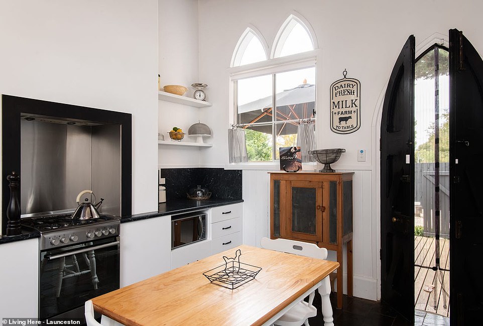 The simple yet chic kitchen is located at the rear of the house and connects to an open-air sundeck in the gravel courtyard and a blackwood shed.