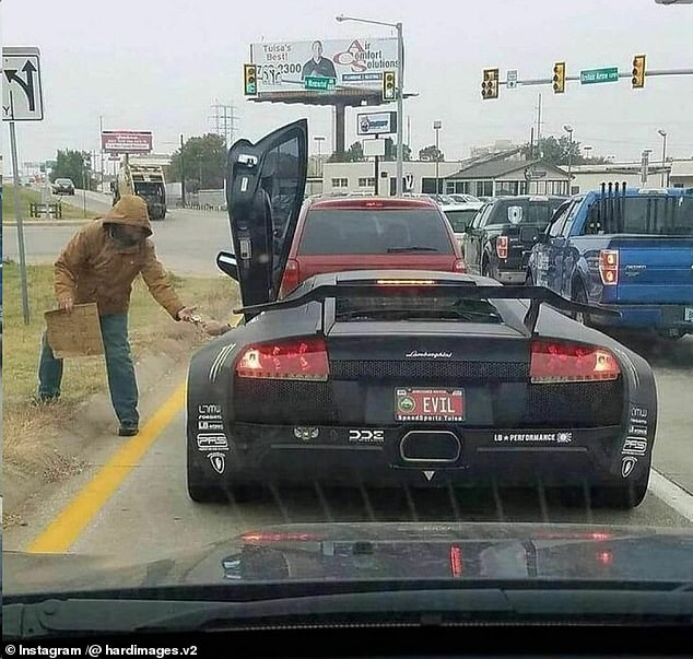 This photo taken in Tulsa, Oklahoma shows a Lamborghini with the license plate 'Evil' giving money to an apparently homeless man