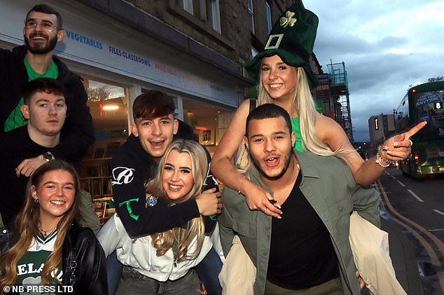 LEEDS: A group of students, decked out in green, pose for a photo as they enjoy the festivities