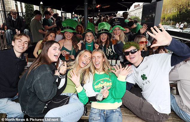 NEWCASTLE: A crowd of partygoers in leprechaun hats and green costumes pose