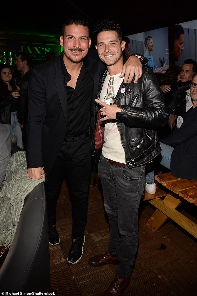 Jax arrived at the venue hours before his estranged wife and seemed in good spirits as he mingled with guests and co-stars.  (Pictured with Wells Adams)