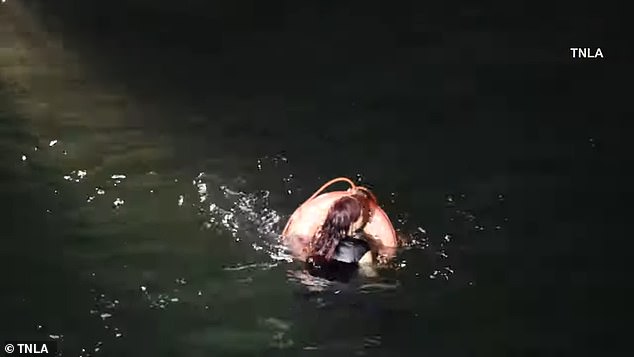 She was seen paddling in the water as officers aboard a Los Angeles Sheriff's Department vessel attempted to rescue her by tossing a floating donut into the ocean.