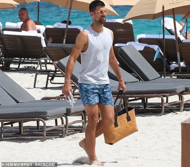 Djokovic completed his beach fit with a gray undershirt and chic sunglasses