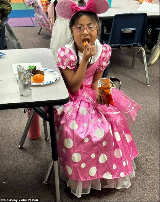 The second grader is seen enjoying a snack at her school while dressed as Minnie Mouse