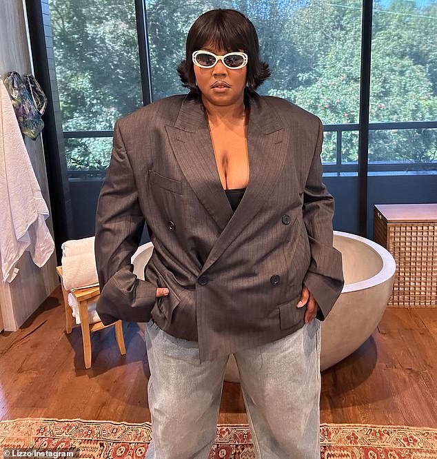 Lizzo, born Melissa Viviane Jefferson, also wore loose-fitting jeans that were offset by white shoes