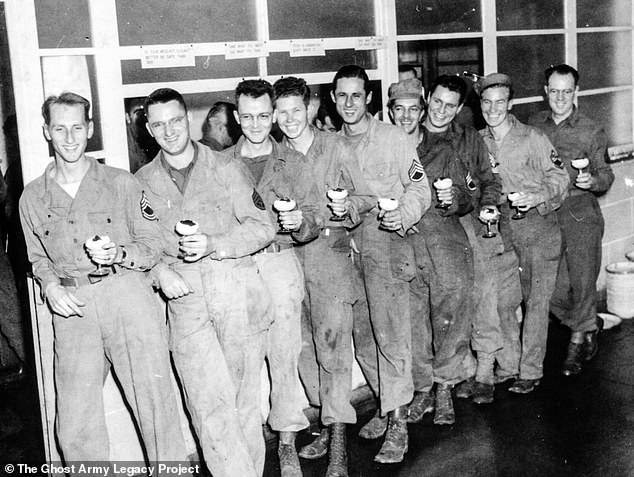 Nine of the 1,100 soldiers stood in line enjoying a well-deserved drink