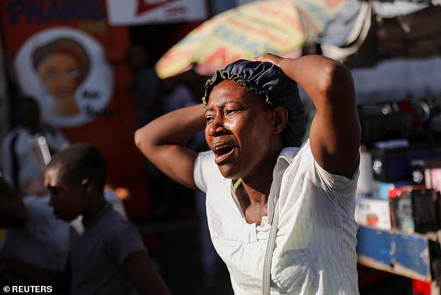 A woman in the capital cries as the bodies of people she knew are removed from the streets