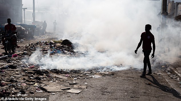 Bodies lay in the rubbish as residents attempted a haphazard cremation on the streets