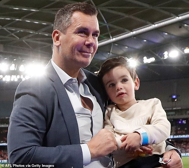 Carey (pictured with son Carter) hasn't touched a drop in just over a fortnight - and there's 'no end date' on how long he'll stay off grog