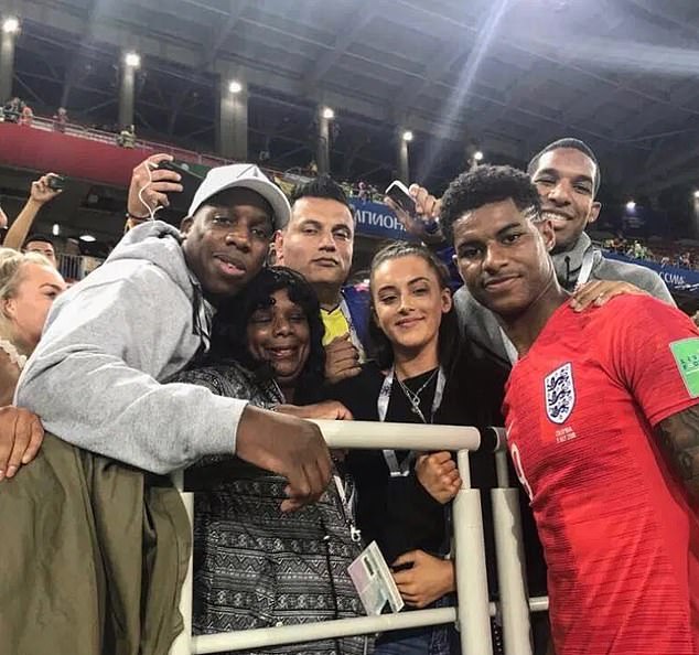 Marcus Rashford is pictured after a World Cup match in Russia in 2018 with his mother Mel center left), brothers Dwaine (far left) and Dane (far right) and girlfriend Lucia Loi (center right)