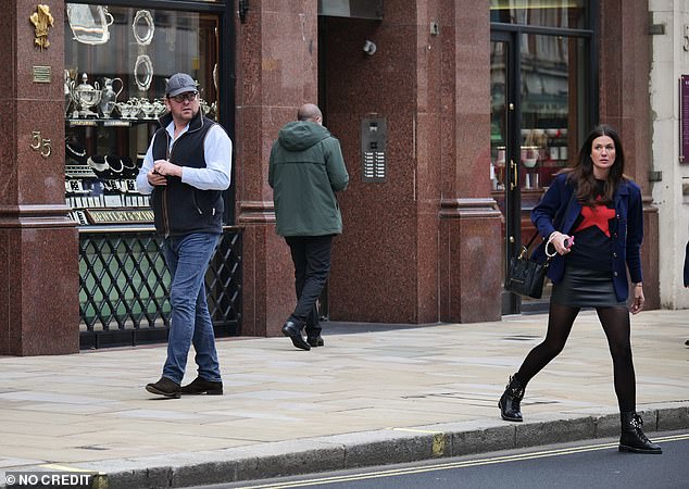 Personal trainer Kim dressed up in a black sweater and a navy blue jacket for the outing, paired with a leather mini skirt