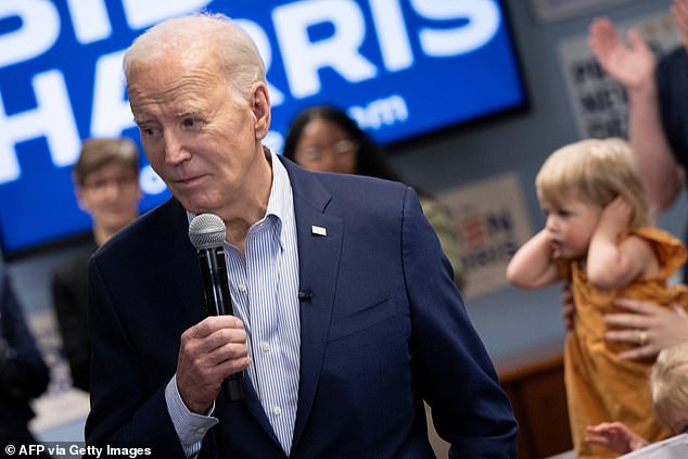 A young girl covers her ears as Biden makes remarks to campaign supporters