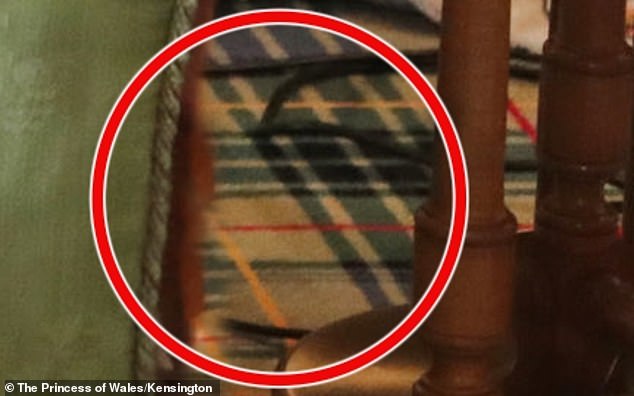 It appears that a black cable on the floor has been cut, with blurring around one end