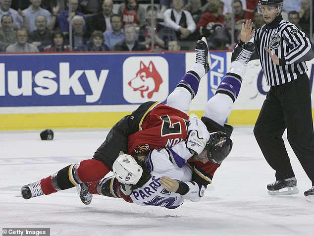 George Parros is turned during a fight with Simon during a match in Calgary in 2006