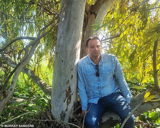 Eran at the tree where his daughter's body was found.  She was identified by her signature flower tattoo on her stomach