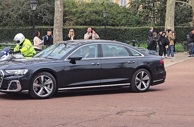 Camilla is seen in the back of the car as she was driven around the Mall today