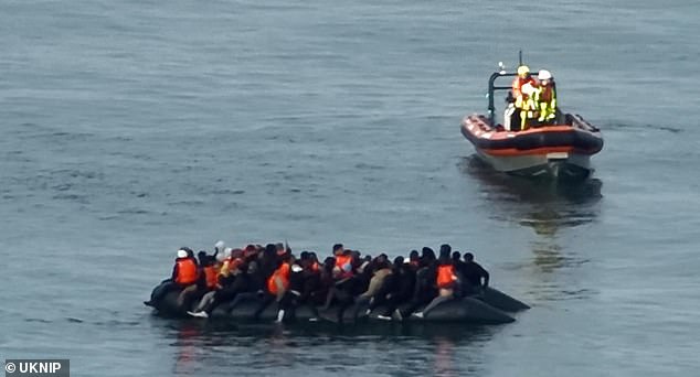 Coast Guard officials were seen approaching the overcrowded boat as it drifted into the open sea