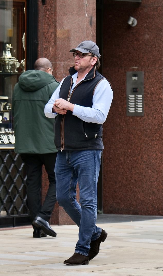 James cut a casual figure for this outing, wearing a black waistcoat with leather trim over a light blue shirt