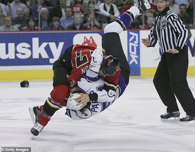 Chris Simon turns over George Parros of the LA Kings during a brawl in Calgary in 2006