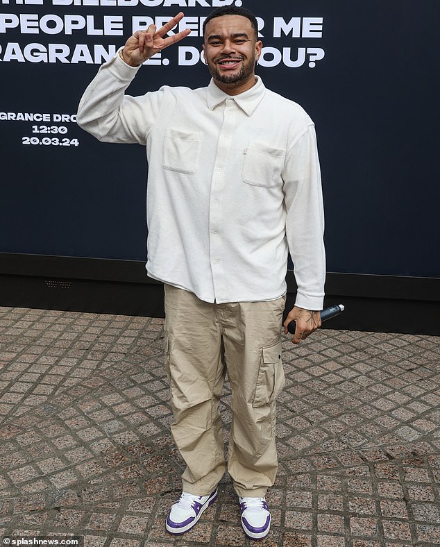 Event host Wes wore an off-white long-sleeved shirt, khaki cargo pants and white and purple sneakers and held a microphone