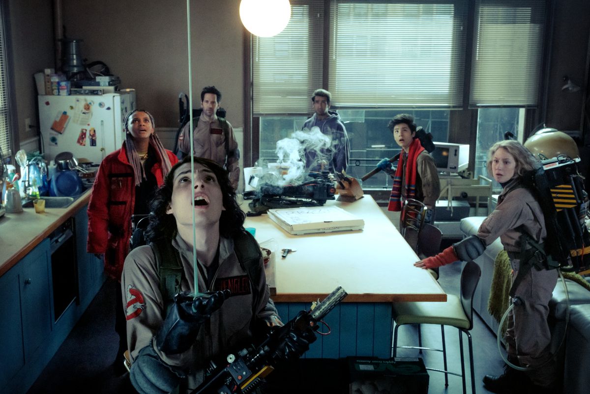 Finn Wolfhard in a Ghostbusters uniform watches slime coming from the ceiling as Kamail Nanjiani, Logan Kim, Paul Rudd and Celeste O'Connor stand behind him in Ghostbusters: Frozen Empire