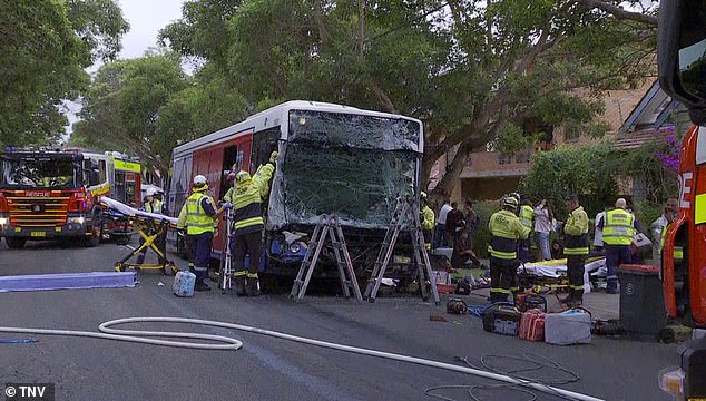 A bus driver and a female passenger were trapped in one of the vehicles, forcing firefighters to smash the windshield (pictured) to rescue the pair