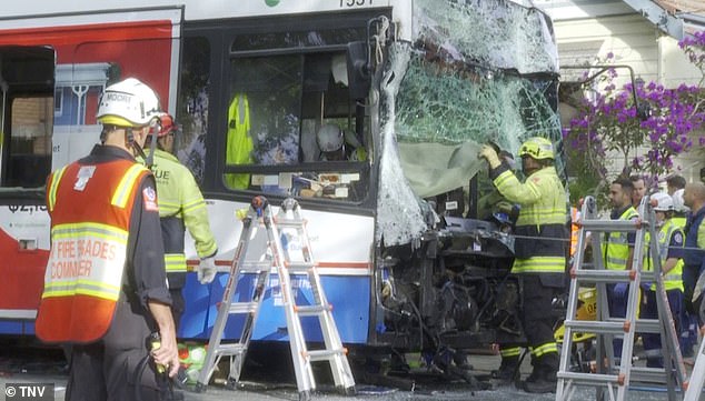 Rescue crews, including firefighters, were seen removing parts of the bus's damaged windshield to evacuate passengers (pictured)