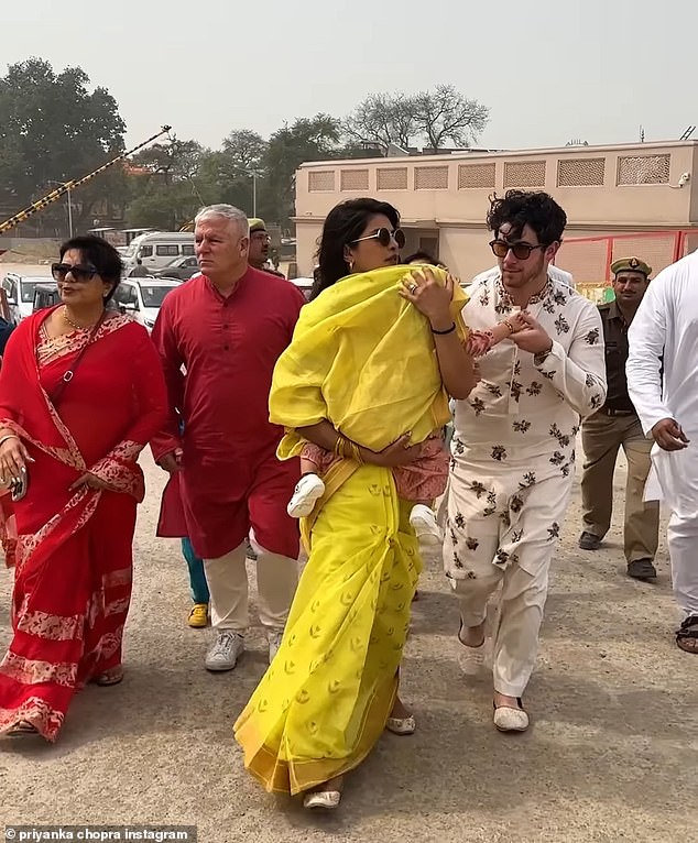 While at the temple, the famous family posed for photos with the priests before leaving