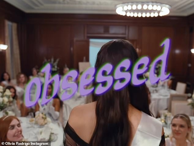 As all the women behind her clap, the pop star slowly turns to the ladies and the song title, 'Obsessed', appears on the screen.