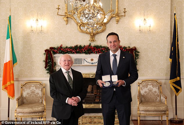 A photo released by Ireland's Government Information Service (GIS) on December 17, 2022 shows Ireland's incoming Prime Minister and Fine Gael party leader Leo Varadkar (R) receiving the Seals of Office of Taoiseach and Government from the Irish President Michael.  D.Higgins