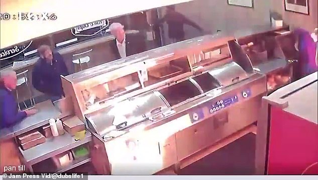 The shocking CCTV footage shows the petrol bomb narrowly missing a female staff member who cowered behind the counter of Zia's takeaway in Dublin