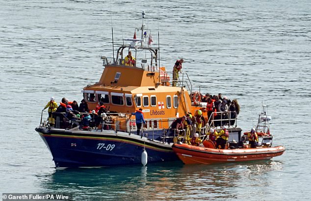 A group of people believed to be migrants are taken to Dover aboard the RNLI Dover Lifeboat following a minor boating incident in the Channel yesterday