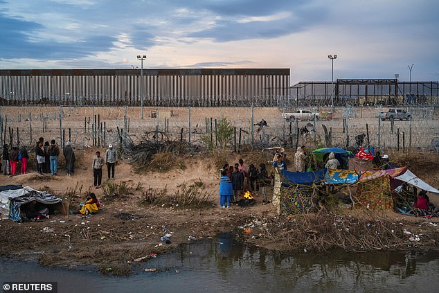 Migrants camp along concertina wire on the U.S. side of the Rio Grande on the day the U.S. 5th Circuit Court of Appeals hears oral arguments on Texas' motion to lift a block on the SB4 immigration law that would allow state officials arrest migrants suspected of being in the country illegally in El Paso, Texas