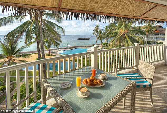 Robert bases himself on the beach, from where he watches the migration of humpback whales.  Pictured: dining on a terrace in his hotel