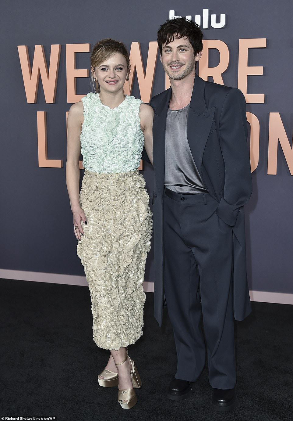 The 32-year-old SAG Award nominee (R) sported significant stubble as he posed in a black maxi blazer over a silky gray top, black pants and black shoes