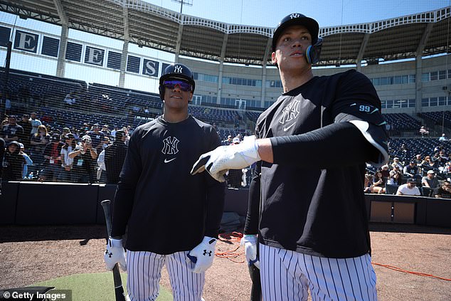 Juan Soto #22 and Aaron Judge #99 of the New York Yankees talk during spring training