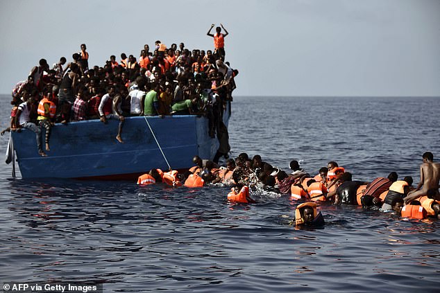 Oumar's first rubber boat was captured by the Libyan coast guard and he was thrown into the notoriously brutal Ain Zara prison in Tripoli (stock photo of migrants 12 nautical miles north of Libya)