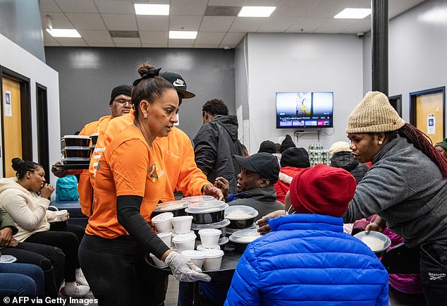 Migrants receive food parcels at a shelter in Chelsea, Massachusetts, in February 2024