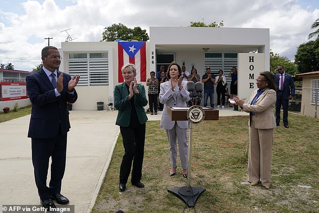 U.S. Secretary of Energy Jennifer Granholm (2nd from left), Deputy Secretary of Housing and Urban Development Adrianne Todman (R) and Governor of Puerto Rico Pedro Pierluisi (L) applaud after U.S. Vice President Kamala Harris speaks