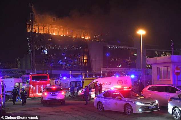 Rescue workers work near the burning Crocus City Hall concert hall after the shooting