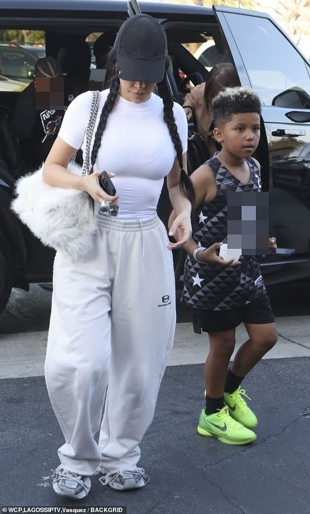 Underneath her hat, Kim braided her long, jet black hair into two braids on either side of her head.