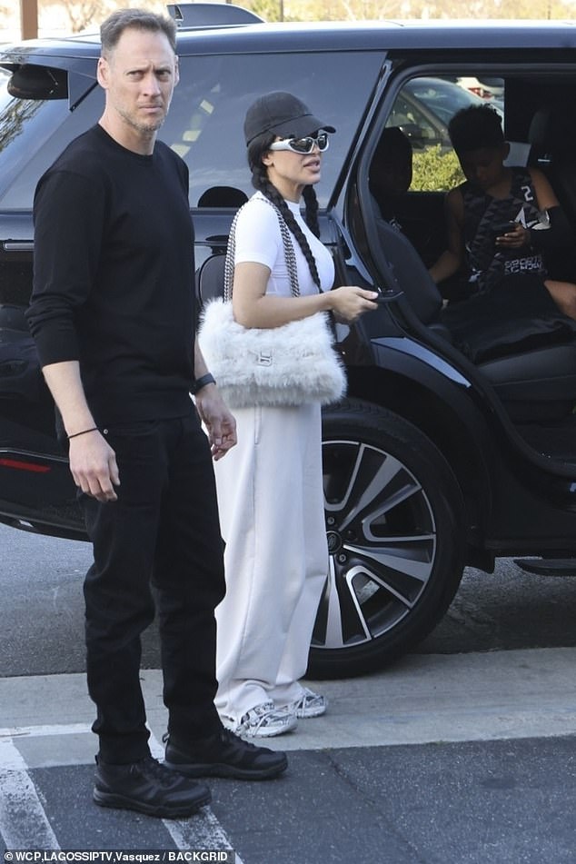 During the outing, Kim sometimes wore sporty, metal, oval sunglasses