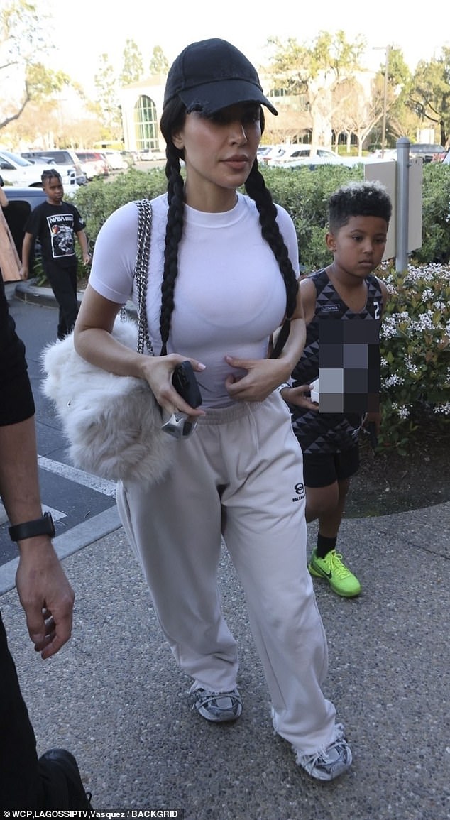 The fashionista carried a fluffy white Balenciaga bag with silver chain straps on her shoulder