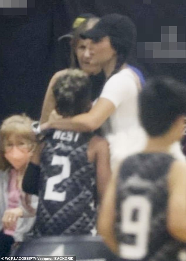 Both Kim and Kanye took turns showing their affection for their son at the basketball event