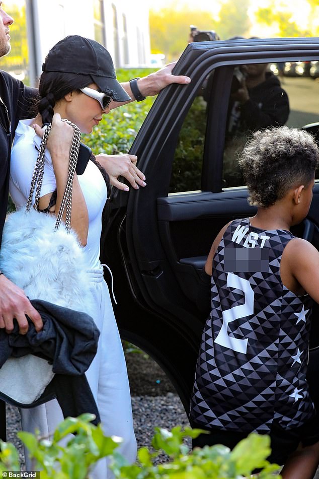 The family was escorted by security as they left the game