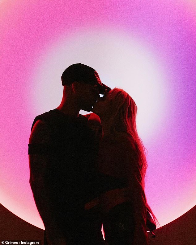 The second photo in her post showed them sharing a kiss as their silhouettes were highlighted by a pink sunset lamp