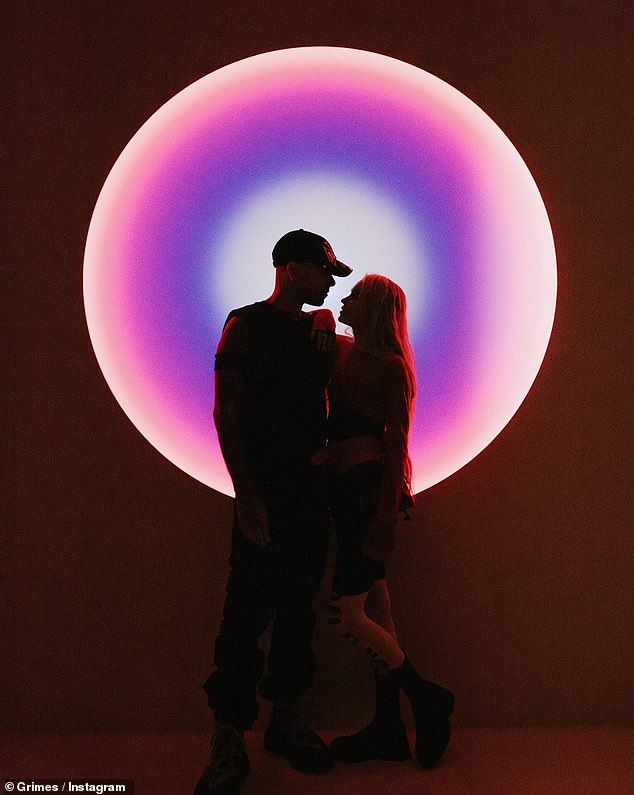 The third photo of the triptych showed Grimes - whose full name is Claire Boucher - leaning on him with her arm on his shoulder as they stared into each other's eyes.