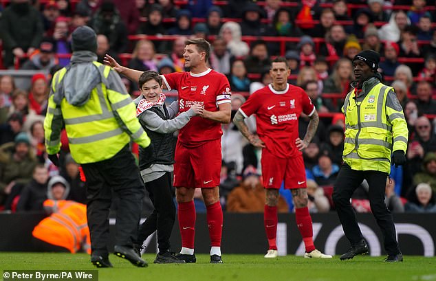 The supporter was then led back across Anfield to the stands by stewards amid applause